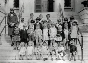 black and white photo of kids on a step