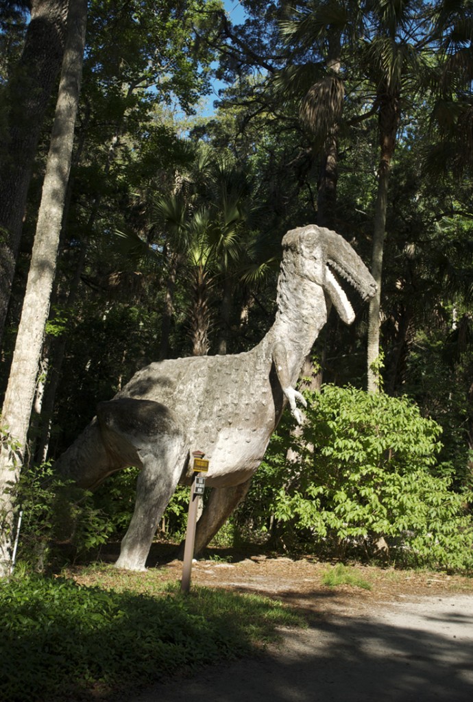 Cement dinosaur emerges through woods in Port Orange, Florida