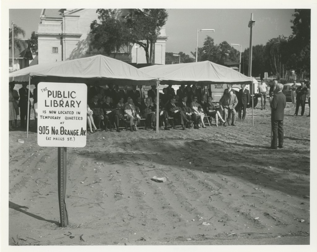 Dirt field with tents full of people for groundbreaking