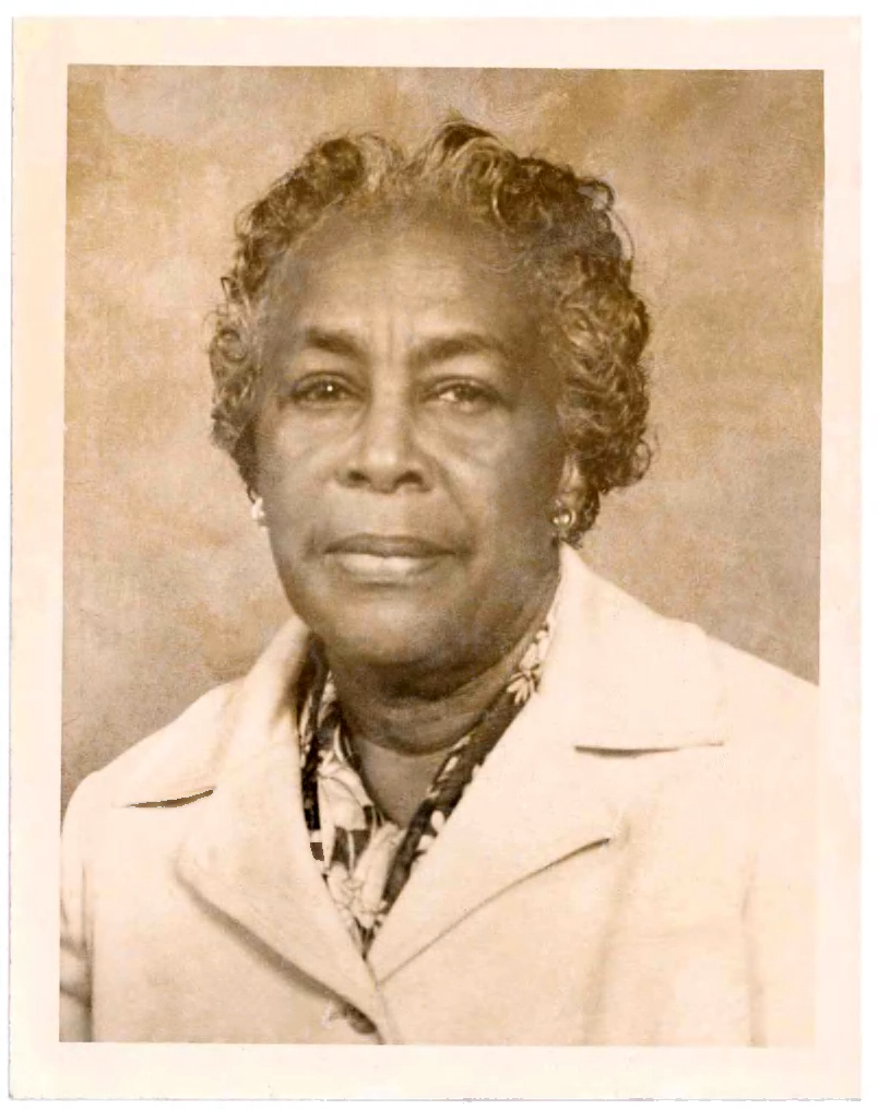 A portrait of Altermese Bentley in a light colored suit jacket and beaded necklace. 